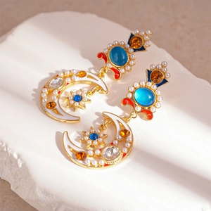 Detail of vintage moon and star earrings with colorful rhinestones and pearls