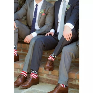 Groomsmen wearing American flag crew socks with formal suits and brown shoes