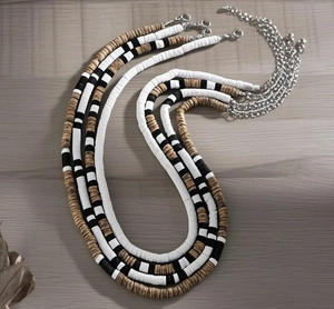 Detailed top view of four-layer bohemian men's necklace with black and white beads