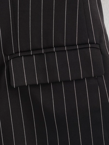 Macro detail of vertical white stripes on black blazer fabric and pocket stitching