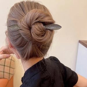 Elegant silver rhinestone leaf hair pin for bun styling shown on female model from back