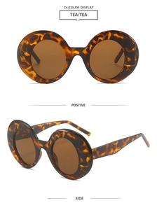 Detail view of round leopard print sunglasses with stylish brown tinted lenses