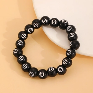 Close-up of a glossy black billiards number 8 bead bracelet with a smooth polished finish