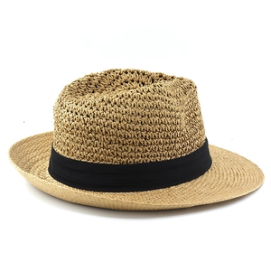 Close-up of woven straw texture and black ribbon detail on a vintage summer fedora