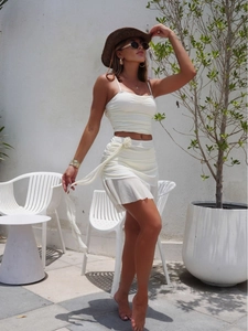Elegant white 2-piece set with ruffled crop top, mini skirt, and 3D floral accent