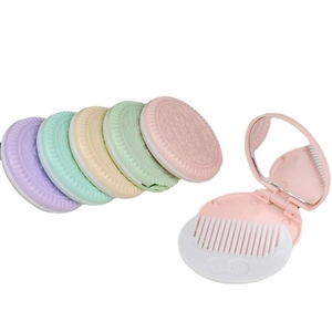 Mini cookie-shaped folding mirror and comb set available in five pastel colors