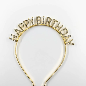 Close-up of golden Happy Birthday headband featuring sparkling rhinestone letters for parties