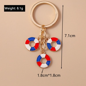 Macro shot of red blue white ring charms on alloy keychain with size and weight info