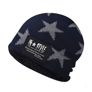 Detail of fleece lining inside the navy knit beanie with grey star patterns