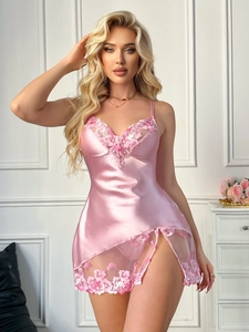 Close-up of pink satin nightgown featuring intricate floral embroidery and lace slits