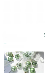 Detail of mint green Christmas ball ornaments in multiple finishes with hanging loops