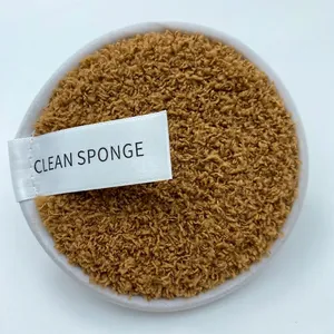 Macro shot of round fiber cleansing sponge with white silk tag and plush brown texture