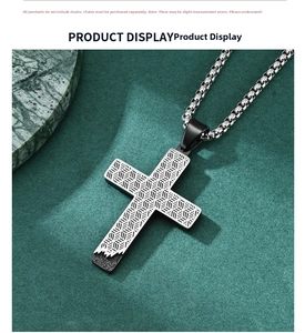 Detailed close-up of a honeycomb cross pendant in silver and matte black stainless steel