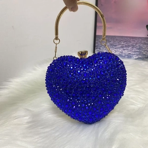 Detail of blue rhinestone heart evening bag with gold ring handle and crown clasp