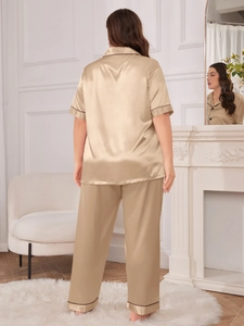 Detail of champagne ice silk pajama set showing smooth satin fabric and contrast piping