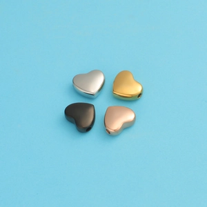 Detail of heart-shaped stainless steel beads in silver, gold, black, and rose gold finishes