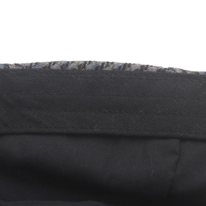 Macro detail of high-quality stitching and internal lining of wool plaid newsboy cap