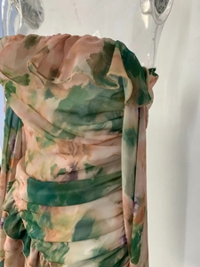 Detail of floral chiffon dress showing ruffle neckline and pleated waist texture