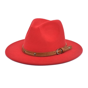 Detail of red fedora wool hat featuring a brown faux leather belt with metal buckle