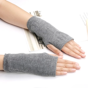 Détail de gants tricotés gris sans doigts montrant la texture respirante et le confort