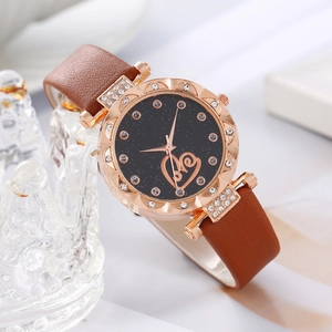 Elegant starry sky dial watch with rose gold heart and brown leather strap on crystal stand