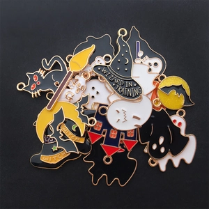 Close-up of assorted Halloween enamel charms including ghosts, bats and wizard hats