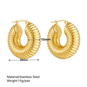 Gold wavy textured hoop earrings in stainless steel with 30mm diameter and 10mm width
