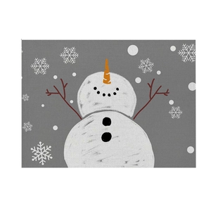 Detail of grey linen placemat featuring a minimalist white snowman and snowflake pattern