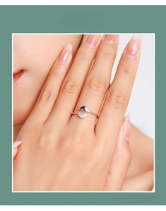 Close-up of S925 sterling silver open ring with double heart design and zircon accents