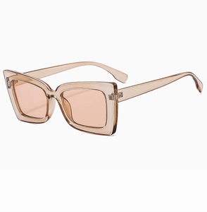 Detail shot of vintage square sunglasses with translucent champagne frames and pink lenses