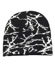 Detailed view of the black and white butterfly pattern knit texture on this warm beanie