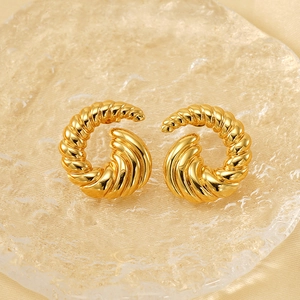 Elegant gold-plated stainless steel spiral hoop earrings on a beige silk background