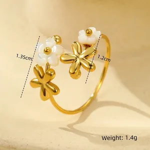 Detail view of 18K gold plated ring with white shell flower charms and 1.4g weight