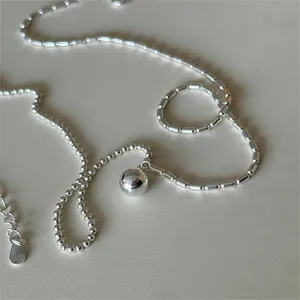 Close-up of S925 sterling silver beaded necklace with solid polished sphere pendant
