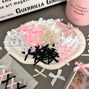 Assorted DIY satin and grosgrain ribbon bows on a ceramic tray for packaging crafts