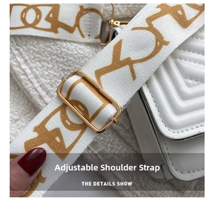 Detail of adjustable textile strap with gold lettering on white quilted leather bag