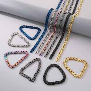 Detail view of colorful Byzantine style chains in blue, silver, rainbow, black and gold steel