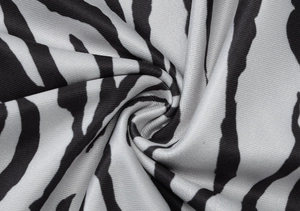 Close-up of zebra print fabric detail showing high-elasticity knit texture and pattern