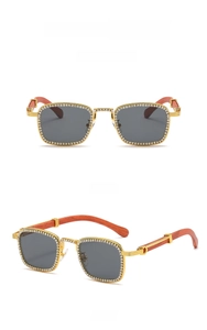 Detail of square gold metal sunglasses featuring diamond frames and wood grain temples