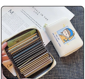 Close-up of accordion style multi-card slots and Girl with a Pearl Earring print card holder