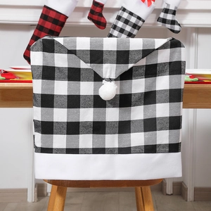 Festive black and white checkered Christmas chair cover with plush pom-pom and white trim