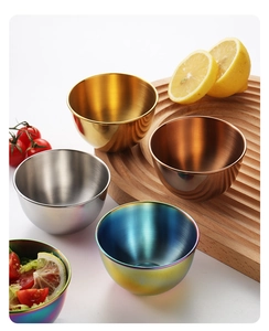 Detailed view of colorful stainless steel dipping bowls with fresh lemon on a wooden board