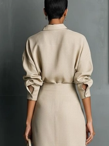 Elegant beige long sleeve shirt and midi skirt set shown from a back view for women
