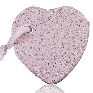 Close-up of heart-shaped pink pumice stone with natural texture and cotton hanging rope