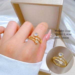 Detailed view of an adjustable gold star heart ring with crystals on 18mm finger size
