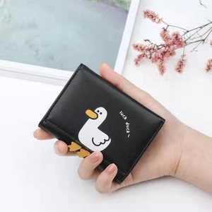 Cute black short wallet for women featuring a white cartoon duck and luck duck text