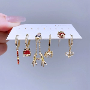 Space-themed gold earring set featuring rocket and planet designs with colorful zircons