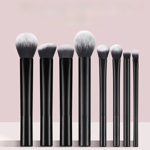 Detailed view of 8 professional makeup brushes with gradient bristles and black tubes