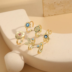 Set of 6 gold adjustable rings featuring evil eye sunflower and butterfly designs