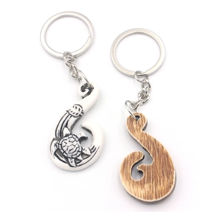 Resin sea turtle carved fish hook keychains in bone white and wood grain finish